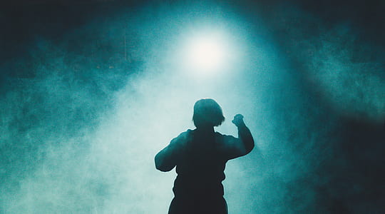 silhouette photography of dancing person surrounded with fogs thumbnail