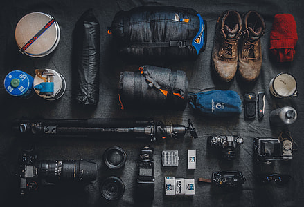 flat lay photography of camera and camping kits thumbnail