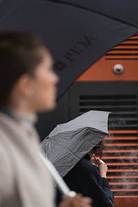 two person using black umbrellas thumbnail
