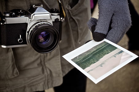 person holding landscape photo thumbnail
