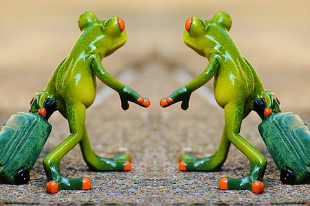 two tree frog figurines holding luggage bags thumbnail