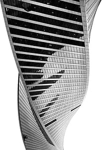 grayscale photo of twisted glass building thumbnail