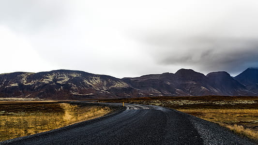 Curve Road Near Mountains during Daytime thumbnail