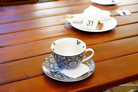 white and black ceramic teacup on white and black saucer thumbnail