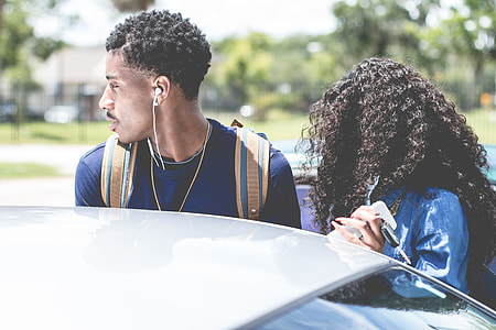 man and woman standing near car thumbnail