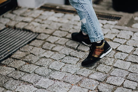 Woman in black sneakers and blue jeans thumbnail