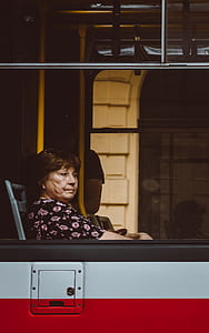 woman sitting on chair near window thumbnail