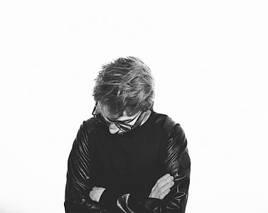 grayscale photography of man in long-sleeve shirt thumbnail