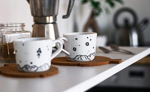 two white ceramic cups with coaster thumbnail