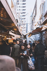 people walking inside market between buildings at daytime thumbnail
