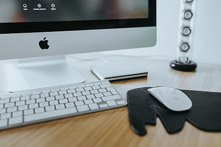 White Apple iMac computer with elephant mousepad thumbnail
