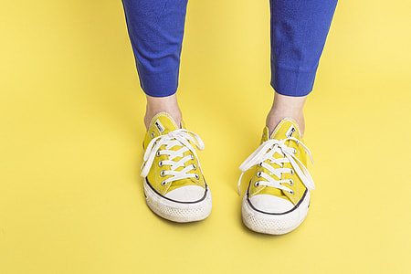 person wearing yellow Converse All Star low-top sneakers thumbnail
