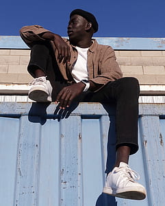 man sitting on top of intermodal container thumbnail