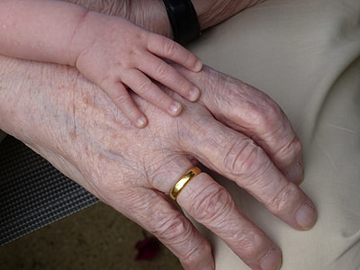 baby hand on top of adult hand thumbnail