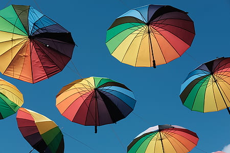 seven assorted-color umbrella under blue sky thumbnail