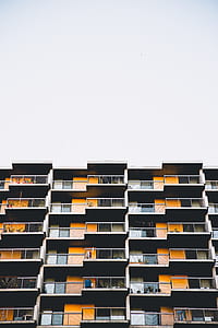 low angle photography of white, yellow, and gray concrete building thumbnail