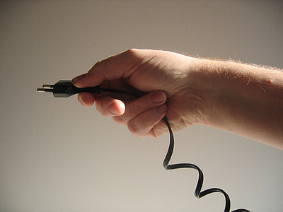person holding black 2-prong adapter thumbnail