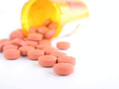 round orange pill lot near brown plastic container thumbnail