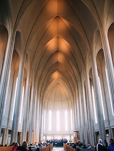 cathedral with choir in the altar and people on pews thumbnail