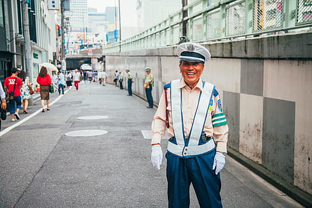 smiling traffic enforcer standing on sidewalk thumbnail