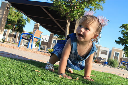 girl on green grass during daytime thumbnail