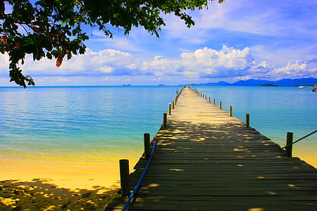 tan wooden sea dock across calm sea during daytime thumbnail
