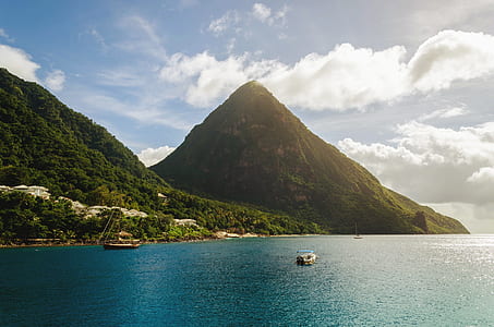 mountain near seashore under white and blue sky thumbnail