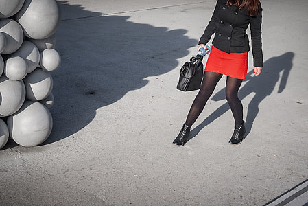 A girl in a bright red dress on the streets of Linz in Austria. Image captured with a Leica thumbnail