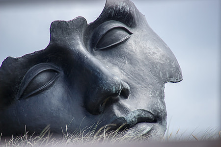 gray concrete face statute on grass thumbnail