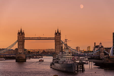 boat near bridge during golden hour thumbnail