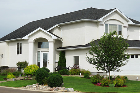 white and black concrete 2-storey house near tree during day thumbnail