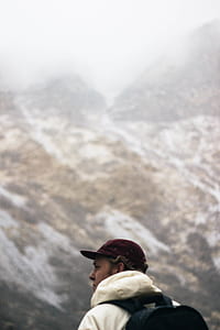 man standing near snowy mountains thumbnail