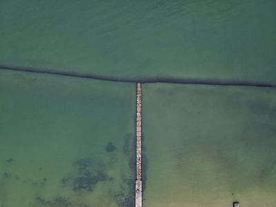 dock surrounded by ocean during daytime thumbnail