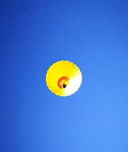 yellow and white hot air balloon flying thumbnail