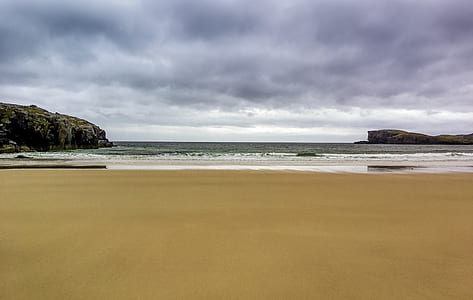brown beach shore under gray sky thumbnail