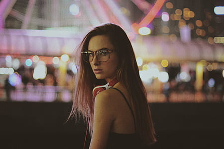 selective photo of woman wearing black camisole looking backwards thumbnail