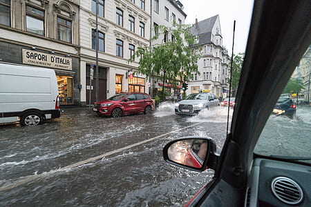 cars passing through flooded streets thumbnail