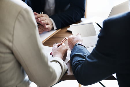 three person writing on table thumbnail