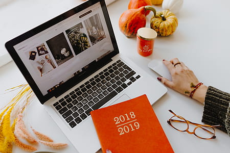 Female desk with orange notebook and pumpkins thumbnail