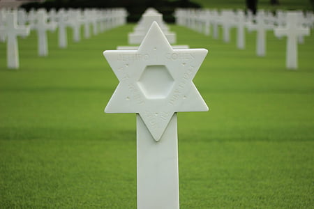 selective focus photography of cemetery cross thumbnail
