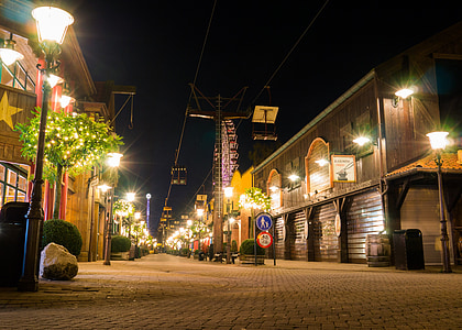 gray concrete road between buildings during nighttime thumbnail