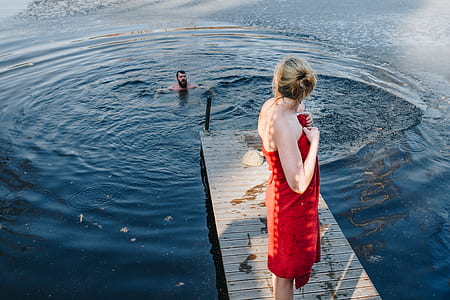 woman standing on dock pier talking to man thumbnail