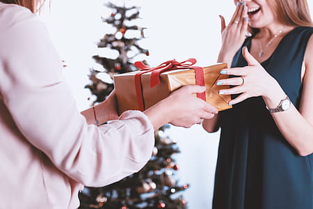 Happy and surprised woman receiving a gift. Merry Christmas thumbnail