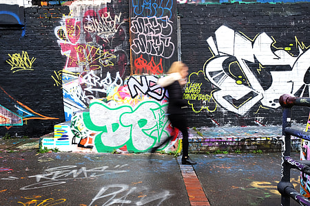 woman walking beside wall thumbnail