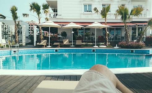 Person Relaxing Near a Swimming Pool thumbnail