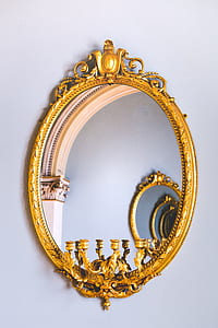 oval gold-colored framed mirror inside room thumbnail