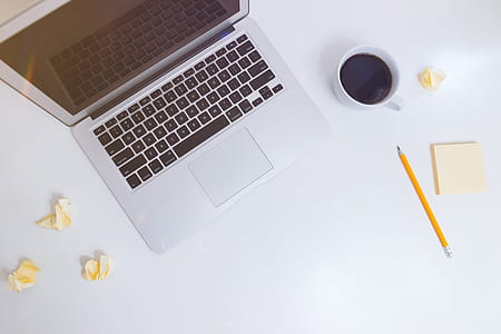 MacBook Air beside white ceramic mug thumbnail