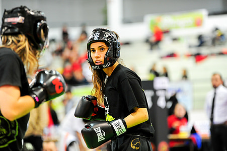 two woman wearing boxing sparing helmet and gloves thumbnail