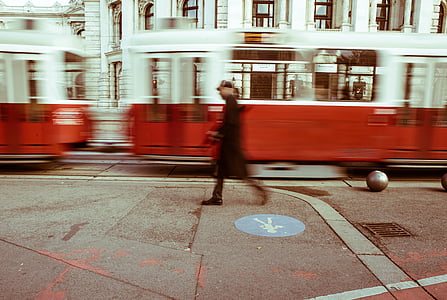 time lapse photo of man walking near train during daytime thumbnail