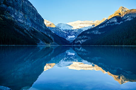 body of water near mountain at daytime thumbnail